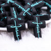 close up view of a pile of Black Cross with Teal writing Silicone Focal Bead Accessory