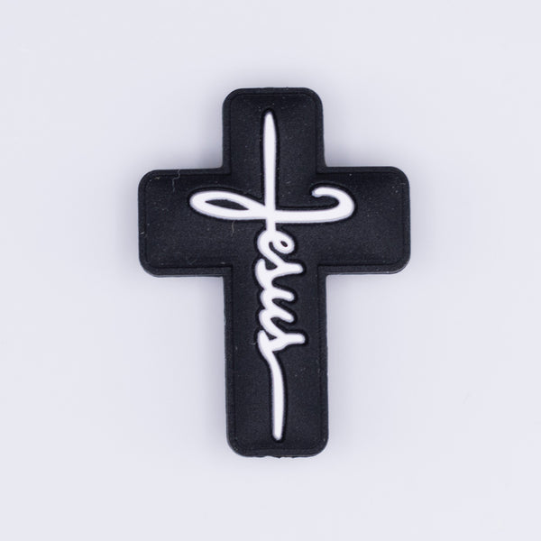 top view of a pile of Black Cross with White writing Silicone Focal Bead Accessory