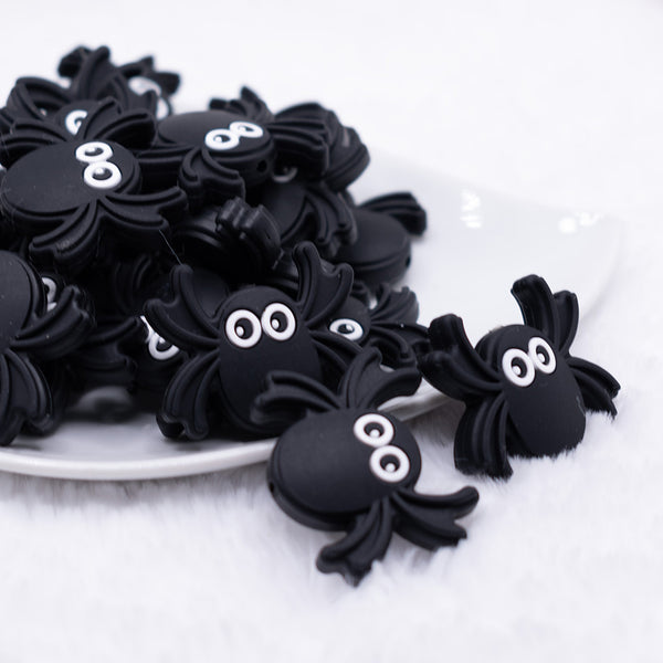 front view of a pile of Spider Silicone Focal Bead Accessory