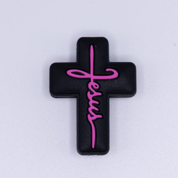 macro view of a pile of Black Cross with Pink writing Silicone Focal Bead Accessory