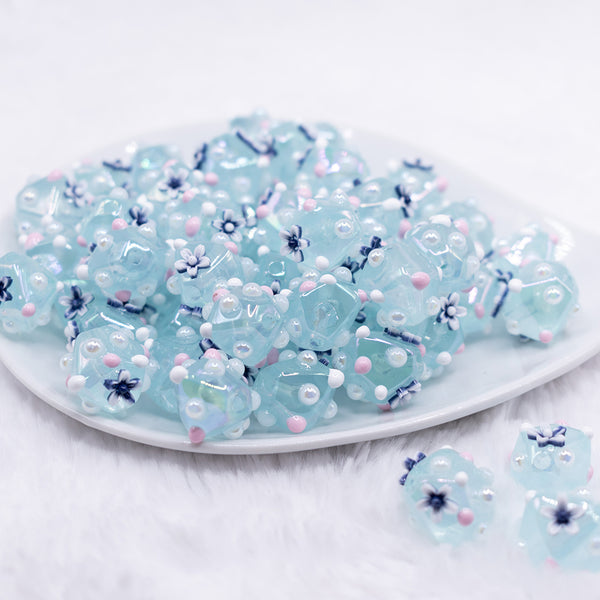front view of a pile of 16mm Blue with Flower luxury acrylic beads