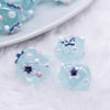 close up view of a pile of 16mm Blue with Flower luxury acrylic beads
