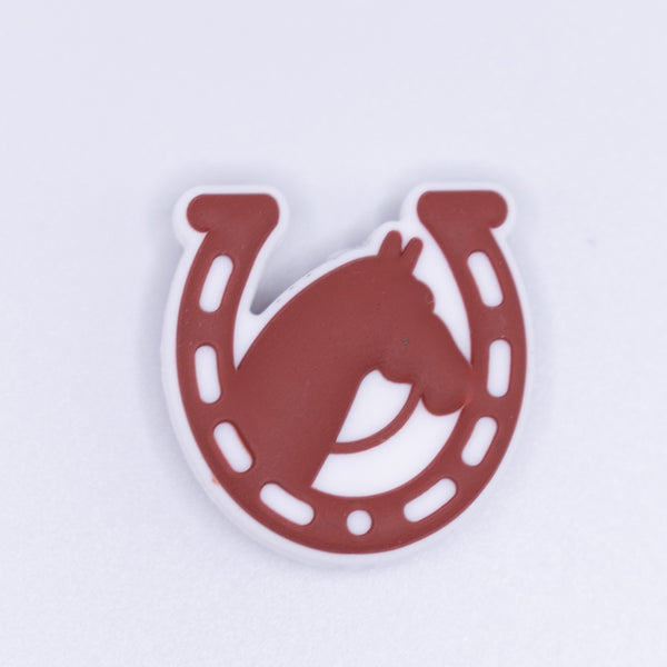 zoomed view of a pile of Brown Horseshoe with Horse Silicone Focal Bead Accessory