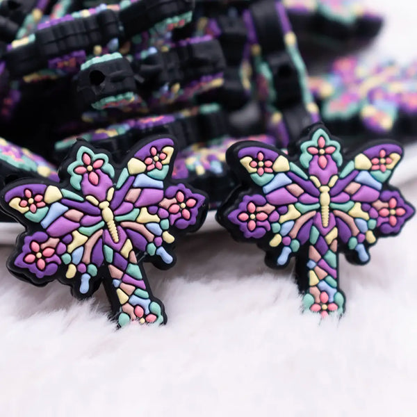 macro view of a pile of Butterfly Cross Silicone Focal Bead Accessory