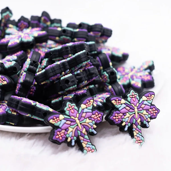 front view of a pile of Butterfly Cross Silicone Focal Bead Accessory