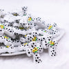 front view of a pile of Cow Cross with Sunflower Silicone Focal Bead Accessory