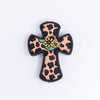 top view of a pile of Cow Print Cross with Flower Silicone Focal Bead Accessory