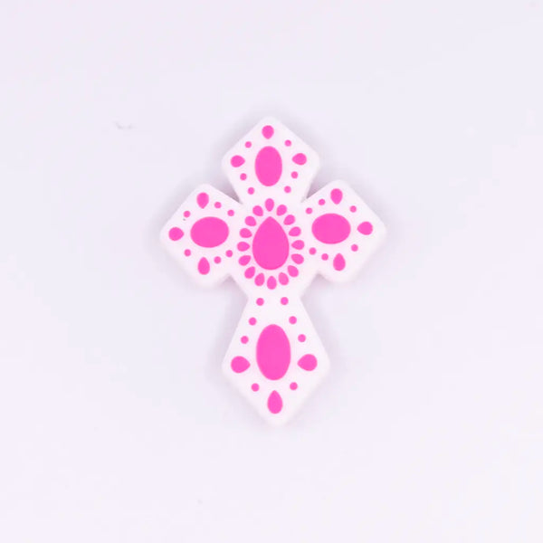 macro view of a pile of Cross with Pink print silicone focal bead