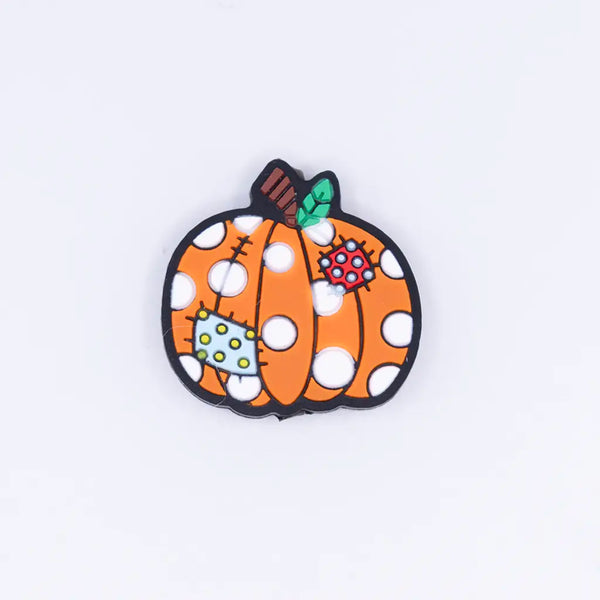 top view of a pile of Fall Pumpkin Silicone Focal Bead Accessory - 27mm x 30mm