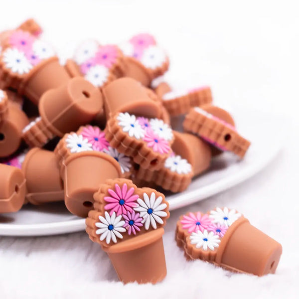 front view of a pile of Flower Bouquet with Brown Pot silicone focal bead