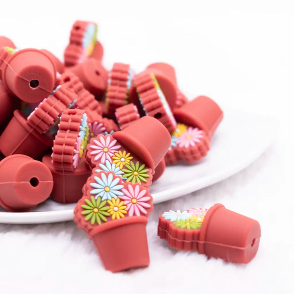 front view of a pile of Flower Bouquet with Rust Pot silicone focal bead