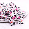front view of a pile of Girly Cow Silicone Focal Bead Accessory