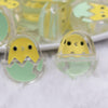 close up view of a pile of 26mm Green Easter Egg with Chick acrylic bead