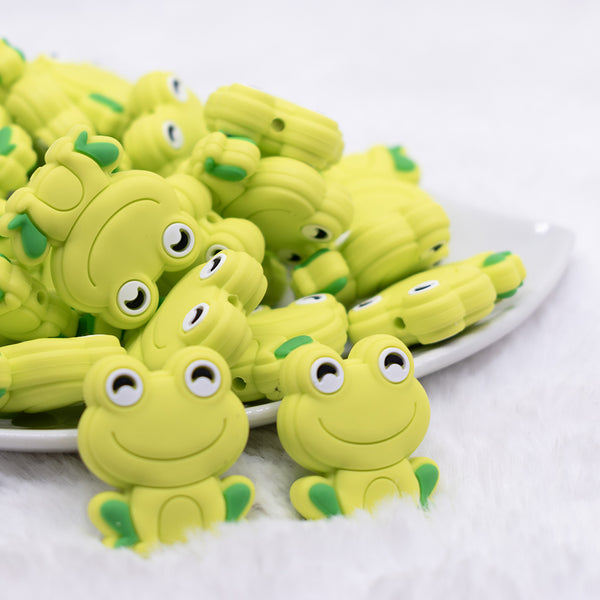 front view of a pile of Green Frog Silicone Focal Bead Accessory