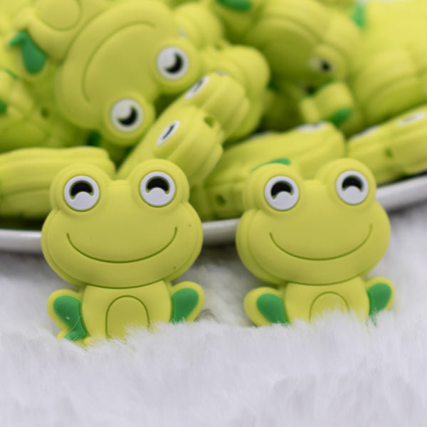 close up view of a pile of Green Frog Silicone Focal Bead Accessory
