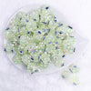 top view of a pile of 16mm Green with Flower luxury acrylic beads