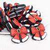 front view of a pile of Christmas Bow Silicone Focal Bead Accessory