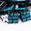 close up view of a pile of I've Got Fillings For You silicone focal bead