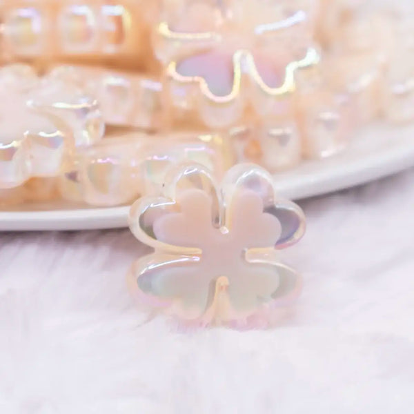 close up view of a pile of 25mm Ivory Clover acrylic bead