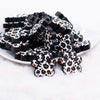 front view of a pile of Leopard Paw Print Silicone Focal Bead Accessory