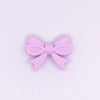 top view of a pile of 25mm Light Purple Bow Knot silicone bead