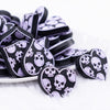 front view of a pile of Lilac Purple Skull Heart Silicone Focal Bead Accessory