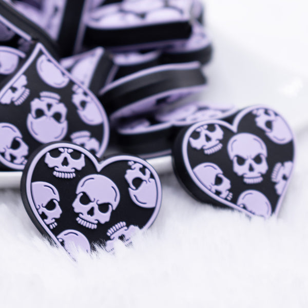 close up view of a pile of Lilac Purple Skull Heart Silicone Focal Bead Accessory