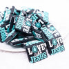 front view of a pile of Love Like Jesus Silicone Focal Bead Accessory