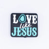 macro view of a pile of Love Like Jesus Silicone Focal Bead Accessory