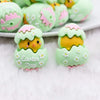 Macro view of a pile of 3D Green Chick Easter Silicone Focal Bead Accessory