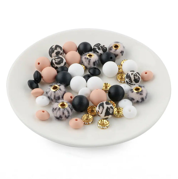 front view of a pile of Cream Animal Print Silicone Variety Bead Pack - 50 Pieces