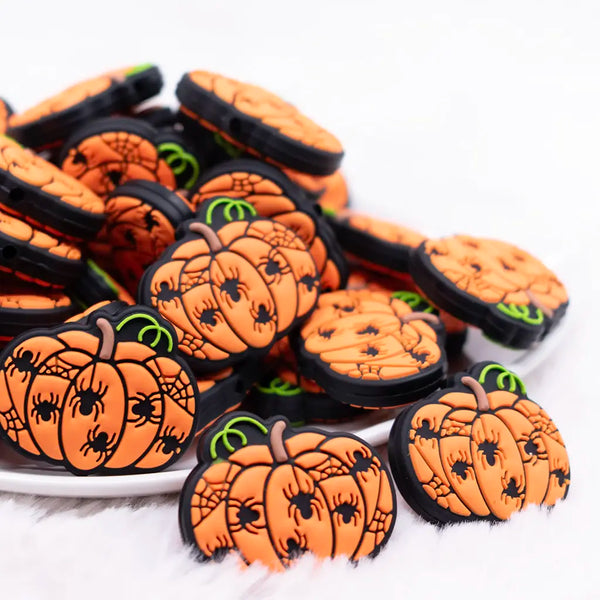 front view of a pile of Orange Pumpkin Silicone Focal Bead Accessory