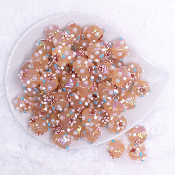 top view of a pile of 16mm Champagne Gold with Flower luxury acrylic beads