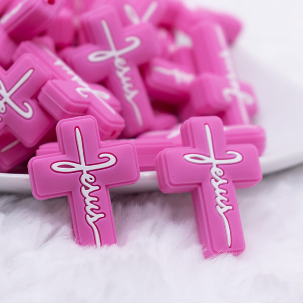 macro view of a pile of Pink Cross Silicone Focal Bead Accessory
