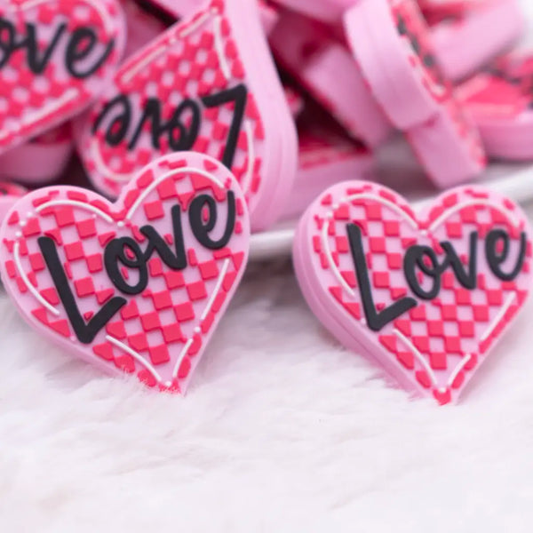 close up view of a pile of Pink Love Heart Silicone Focal Bead Accessory