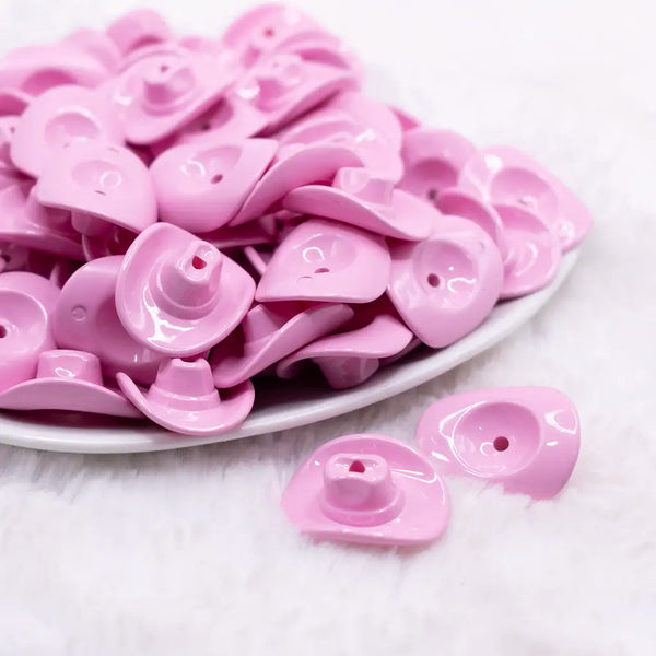 front view of a pile of Pink Cowboy Hat Acrylic Focal Bead