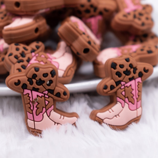 close up view of a pile of Pink Cowgirl Boot Silicone Focal Bead Accessory