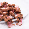 front view of a pile of Pink Cowgirl Boot Silicone Focal Bead Accessory