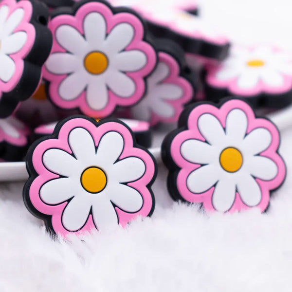 close up view of a pile of Pink Daisy Silicone Focal Bead Accessory