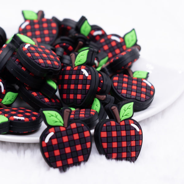 front view of a pile of Plaid Apple Silicone Focal Bead Accessory