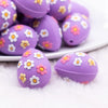 close up view of a pile of 3D Purple Egg with Flowers Silicone Focal Bead Accessory