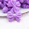 close up view of a pile of 25mm Purple Bow Knot silicone bead