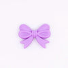 top view of a pile of 25mm Purple Bow Knot silicone bead