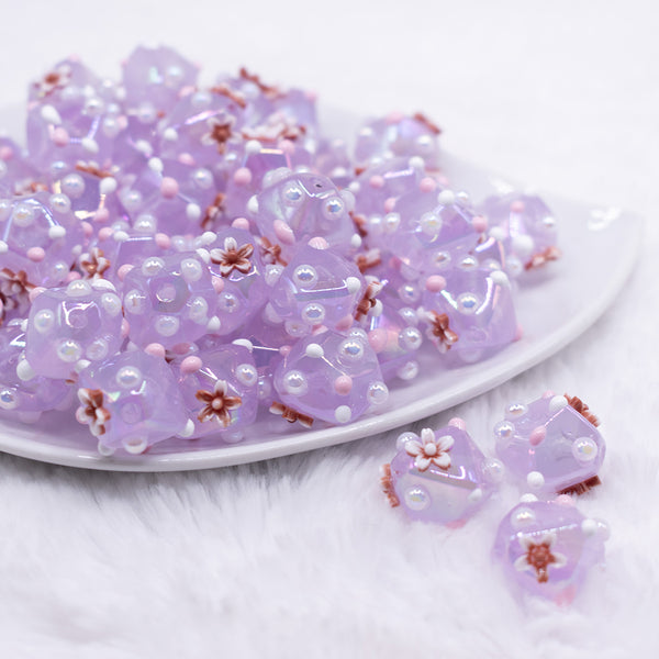 front view of a pile of 16mm Purple with Flower luxury acrylic beads