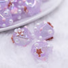 close up view of a pile of 16mm Purple with Flower luxury acrylic beads