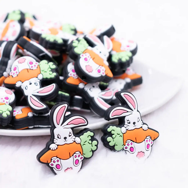 close up view of a pile of Rabbit with Carrot Silicone Focal Bead Accessory