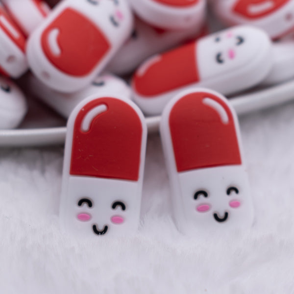 close up view of a Red and White Pill Silicone Focal Bead Accessory