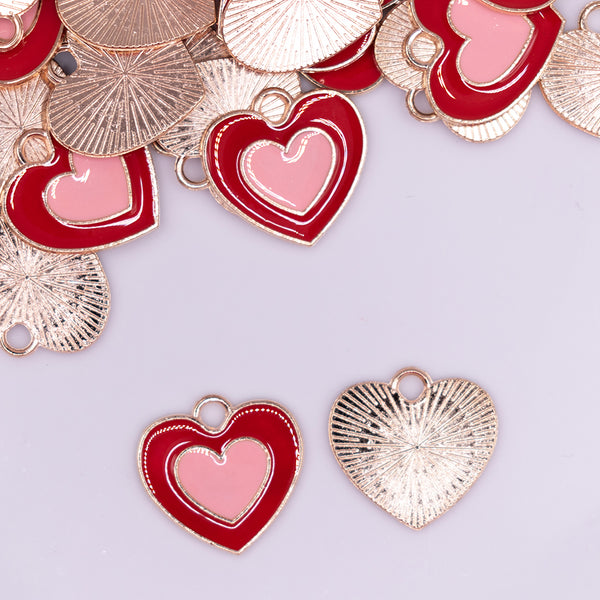 close up view of a pile of Red and Pink Heart charm with gold plating