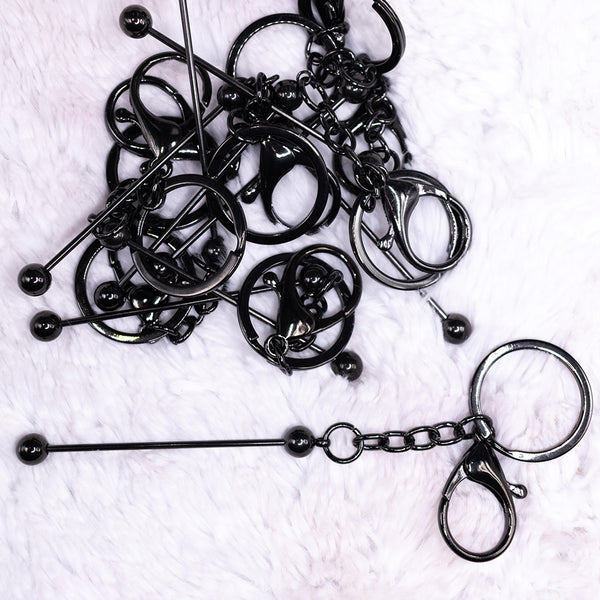 top view of a pile of Shiny Black Beadable Keychain - 1 & 5 Count