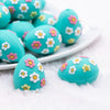 close up view of a pile of 3D Teal Egg with Flowers Silicone Focal Bead Accessory